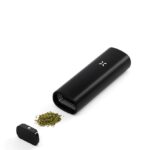 Black Usb-rechargeable Portable Grinder with Its Lid off and Green Ground Herb Spilling Onto a White Surface - Australia E-cigarette Store