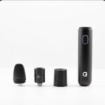 Disassembled Vape Pen with Mouthpiece Coil Connector and Cylindrical Battery on a White Surface - Australia E-cigarette Store