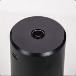 Black Cylindrical Speaker with a Circular Top Surface and a Small Central Buttonmicrophone Plus a Usb-c Port Visible on the Side Set Against a Light Background - Australia E-cigarette Store